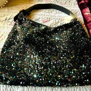 Purse with iridescent sequins. Gold buckle on handle. Zipper on each end.